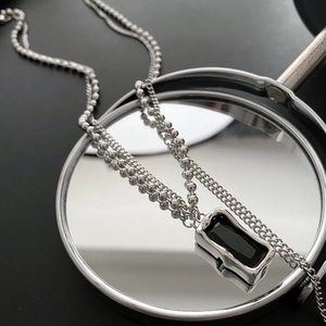 Minimalist double layered silver necklace with a rectangular black gemstone pendant