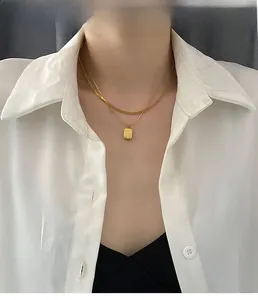 French style double-layer gold necklace with snake chain and rectangular pendant on model