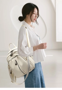 Detail of off-white lychee grain PU leather backpack with geometric pattern strap