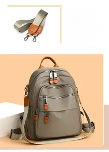 Detail view of water-resistant nylon backpack with leather accents and wide strap