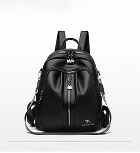Close-up of black litchi pattern PU leather backpack with silver zippers and kangaroo logo