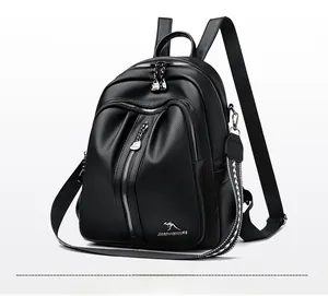 Detailed view of black litchi grain PU leather backpack with woven strap and metal zippers
