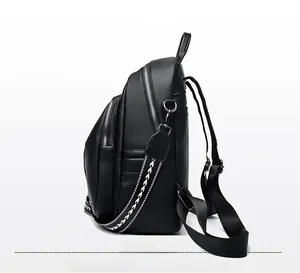 Side view of black lychee grain PU leather backpack with decorative woven strap and silver zippers