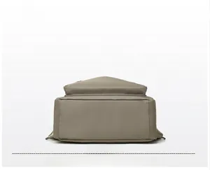 Detailed bottom view of high quality khaki nylon backpack showing wide base and stitching