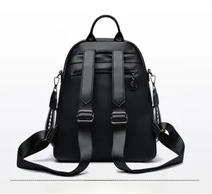 Rear view of black lychee grain PU leather backpack with anti-theft zipper pocket