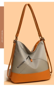 Dettaglio della borsa in nylon grigio con base in pelle marrone e tasca con cerniera