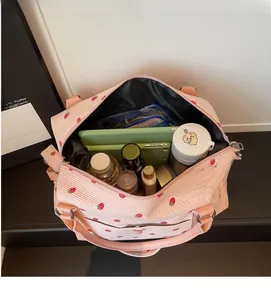 Internal view of large capacity strawberry print travel bag showing spacious storage space