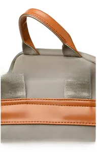 Detail of premium nylon backpack featuring orange faux leather handle and sturdy stitching