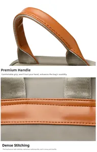 Detail of durable grey nylon fabric with reinforced brown leather handle and fine stitching