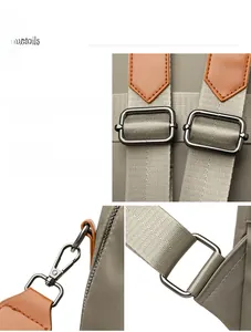 Detail of shiny metal buckle and adjustable strap on large nylon backpack for school
