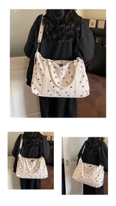 Detail view of large canvas tote bag with strawberry print and sturdy shoulder straps