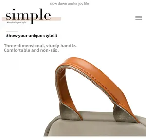 Detail of grey nylon backpack featuring ergonomic brown leather handle and sturdy stitching