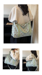 Detailed views of light green corduroy travel bag featuring red strawberry embroidery