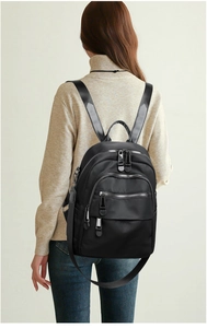 Detailed back view of a black multi-functional backpack on a model for casual travel
