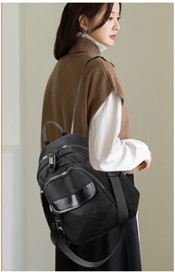 Side view of multi-compartment black nylon backpack showing its ergonomic water-repellent design
