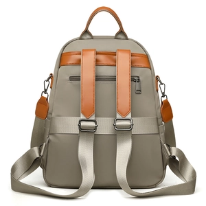 Khaki nylon travel backpack for women with brown leather trim and anti-theft back pocket