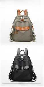 Detail view of grey and black nylon backpacks with leather zip pullers and handles