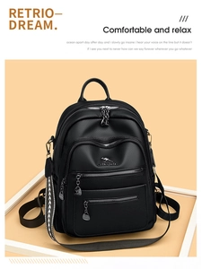 Close-up of black lychee grain leather backpack with kangaroo logo and textured zippers