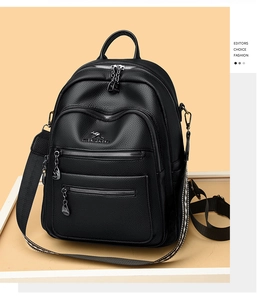 Close-up of black litchi grain leather backpack with kangaroo logo and zip pockets