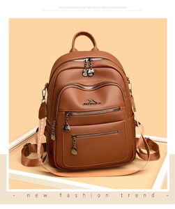 Detail of dark brown pebble leather backpack with silver hardware and tribal strap