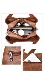 Detail view of brown leather shoulder bag featuring multi-compartments and silver hardware