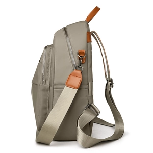 Versatile khaki nylon backpack with brown leather accents and multi-layered side structure