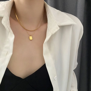 Double-layered gold titanium steel necklace featuring snake chain and lucky pendant