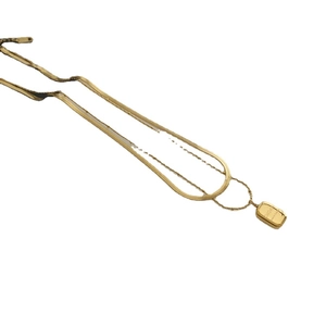 Double-layered golden necklace featuring snake chain and engraved rectangular pendant