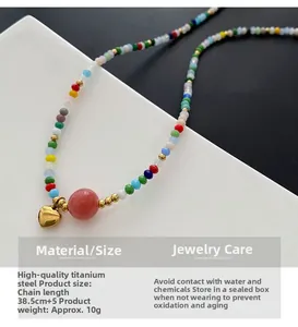 Detail of colorful beaded necklace with gold heart pendant and premium steel chain