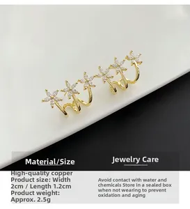 Detailed view of gold flower earrings with marquise crystals and size dimensions
