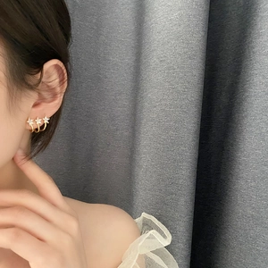 Three gold star flowers ear climber with white cubic zirconia stones in 925 silver