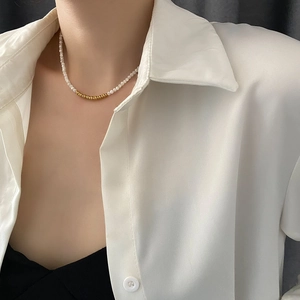 Elegant beaded titanium steel necklace featuring white pearls and golden metallic spacers