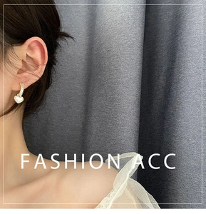 Detail of heart drop earring with white mother-of-pearl and gold-plated zircon inlay