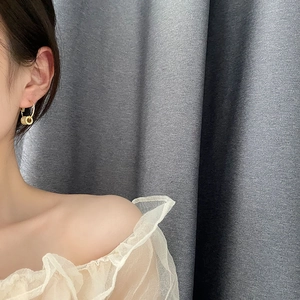 Elegant gold double circle hoop earrings with zircon stones on a female model