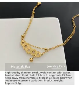 Detail of double-layer titanium steel anklet with vintage gold coins and bead accents