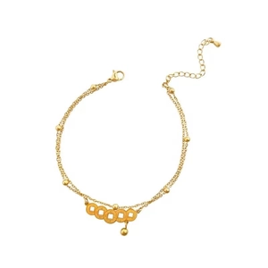 Double-layered gold anklet with vintage coins and beads on a minimalist chain