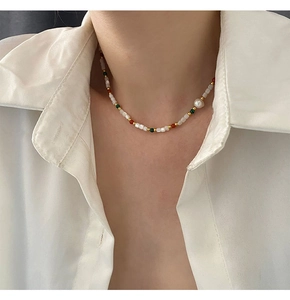 Detail of freshwater baroque pearl necklace with colorful agate and malachite beads