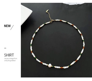 Macro detail of natural baroque pearl and colorful beads on a vintage beaded necklace
