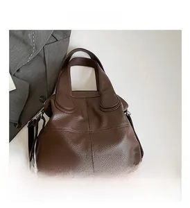 Detailed view of the brown lychee pattern leather tote bag with top zipper and strap
