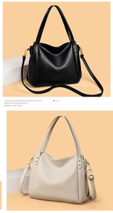 Detail view of large bucket bag in black and beige with pebbled leather and gold hardware