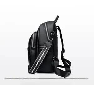 Detail view of black pebbled leather backpack with silver hardware and woven strap