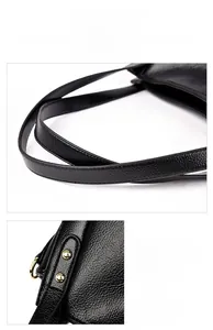 Detailed view of the black lychee pattern leather handles and metal hardware on tote bag