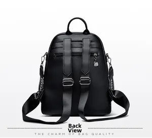 Detail of black pebbled leather backpack rear showing straps and anti-theft zipper pocket