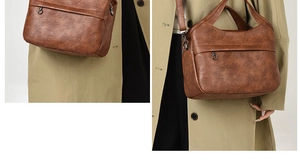 Detail view of vintage dark brown faux leather handbag with multiple zip pockets