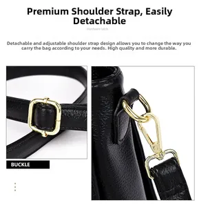 Detail of adjustable shoulder strap with golden metal hardware on black textured leather bag