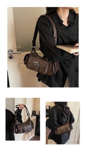 Close-up of retro brown motorcycle bag with functional side pockets and belt buckle details