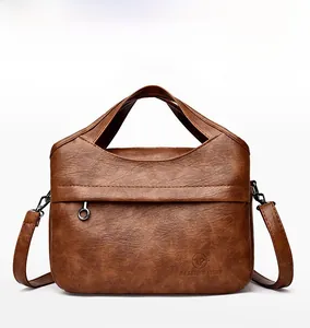 Detailed front view of brown textured tote bag featuring a metal ring and embossed logo