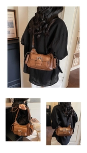 Detail of vintage brown PU leather crossbody bag featuring side pockets and buckle flap