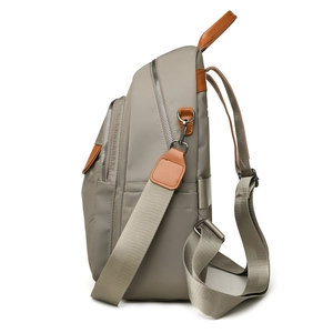 Grey-green nylon large capacity backpack with brown leather trim and side view structure
