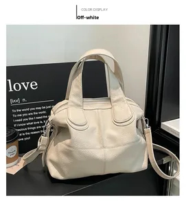 Detail of off-white lychee pattern leather handbag with cross stitching and strap